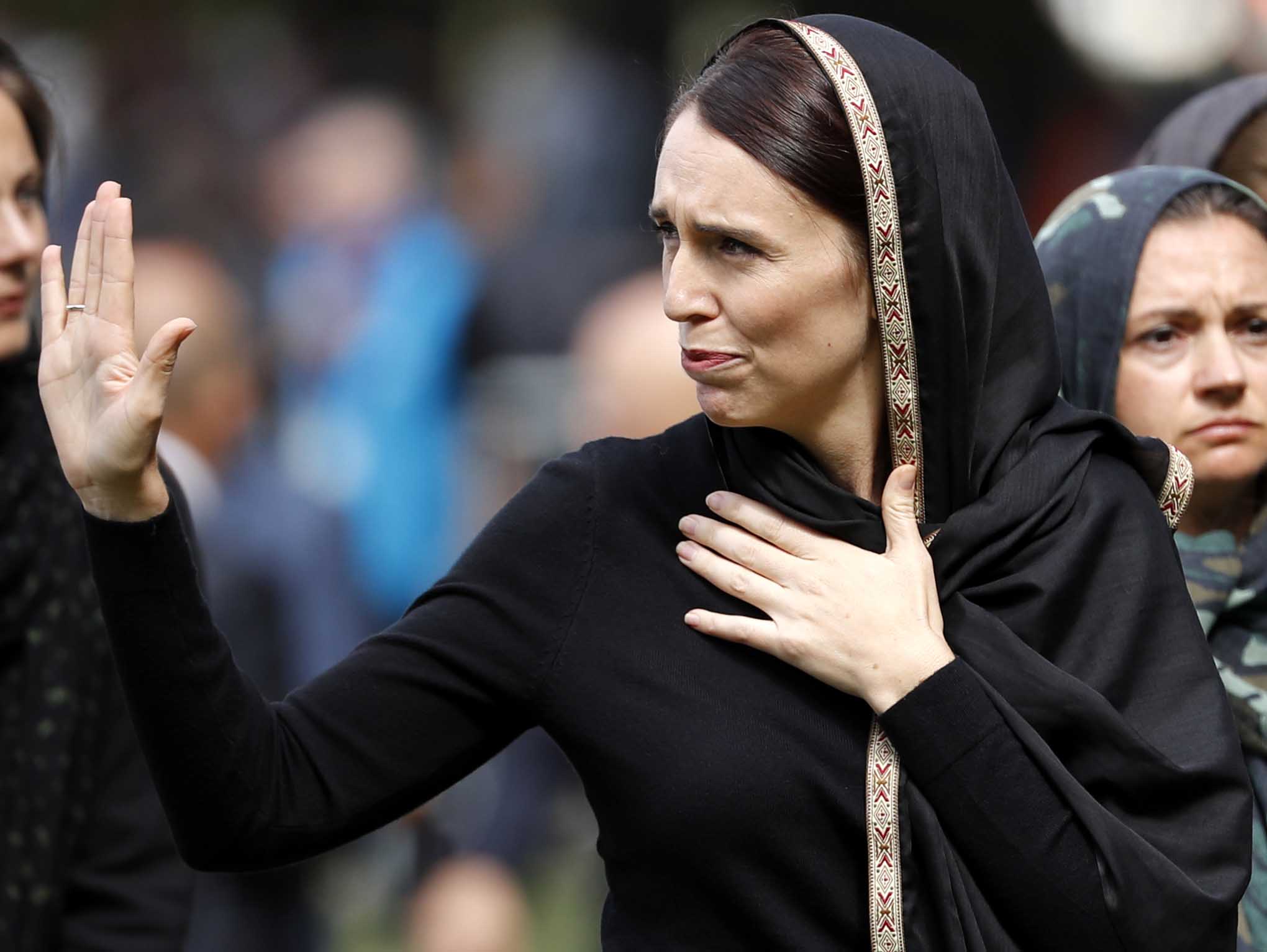 New Zealand Prime Minister Jacinda Ardern, center, waves as she leaves Friday prayers at Hagley Park in Christchurch, New Zealand, Friday, March 22, 2019. People across New Zealand are observing the Muslim call to prayer as the nation reflects on the moment one week ago when 50 people were slaughtered at two mosques. (AP Photo/Vincent Thian)