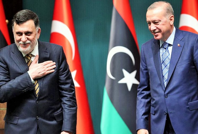 (FILES) In this file photo taken on June 4, 2020, Turkish President Recep Tayyip Erdogan (R) and Libyan Prime Minister Fayez al-Sarraj (L) hold a joint press conference at the Presidential Complex in Ankara. - Ten years after Libya's NATO-backed uprising ousted and killed dictator Moamer Kadhafi, the country remains wracked by conflict and chaos, its population bled dry despite the nation's vast oil wealth. A UN-led process has lifted cautious hopes that the latest fragile ceasefire will bring a lasting peace, but, for now, Libya is split in two by rival camps with their own militias, mercenaries and foreign backers. (Photo by Adem ALTAN / AFP)