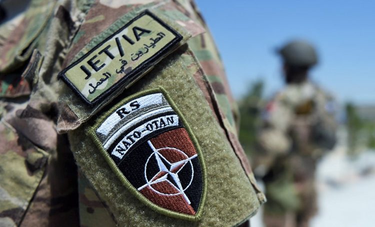A German soldier from the NATO coalition stands guard during a visit by resolute support spokesman Brigadier General H. Cleveland outside the Shaheen 209th military corps training center in Mazar-i-Sharif on April 26, 2016. 
There are around 13,000 NATO troops stationed in Afghanistan, officially in a training and advisory role since the end of their combat mission in 2014.  / AFP / WAKIL KOHSAR        (Photo credit should read WAKIL KOHSAR/AFP/Getty Images)