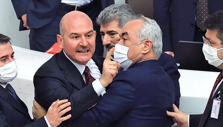 Turkey Interior Minister Suleyman Soylu (2L) gestures towards the opposition Republican People's Party deputies while discussing the 2022 budget of the Ministry of Interior at Turkish Grand National Assembly in Ankara on December 8, 2021. (Photo by Adem ALTAN / AFP)