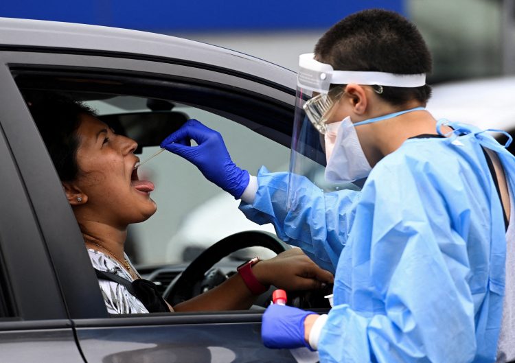 A woman takes a test for the coronavirus disease (COVID-19) at a testing centre in Sydney, Australia, January 5, 2021.  REUTERS/Jaimi Joy