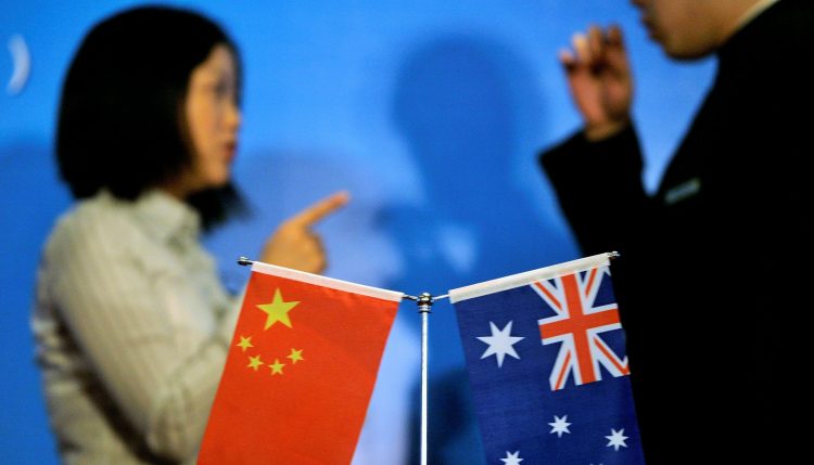 FILE PHOTO: Staff members chat as they prepare a seminar of Australia China bilateral cooperation in resources and infrastructure in West Australia, in Beijing July 23, 2009. REUTERS/Jason Lee