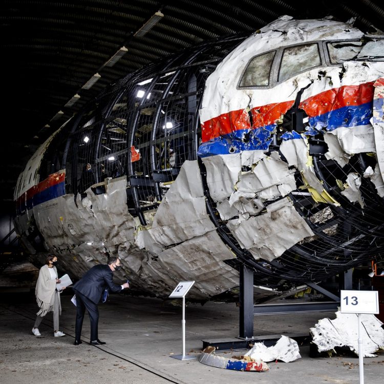 Trial judges and lawyers view the reconstructed wreckage of Malaysia Airlines Flight MH17, at the Gilze-Rijen military Airbase, southern Netherlands on May 26, 2021. - Judges inspect wreckage of flight MH17 as part of criminal trial of four suspects. (Photo by Sem van der Wal / ANP / AFP)