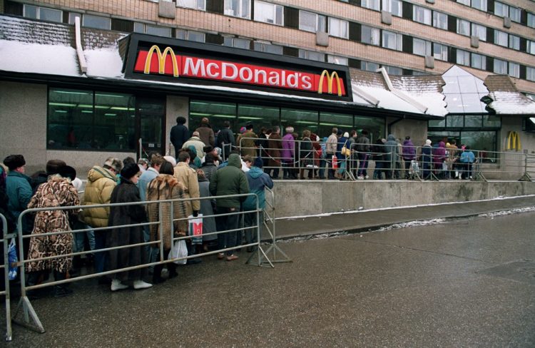 Des Moscovites font la queue, le 01 février 1992 à Moscou, devant l'enseigne de restauration rapide américaine, McDonald's. Pour faire face à la pénurie alimentaire, les Russes doivent attendre parfois jusqu'à deux à trois heures par jour devant les magasins. AFP PHOTO DIMA KOROTAYEN (Photo by DIMA KOROTAYEN / AFP)
